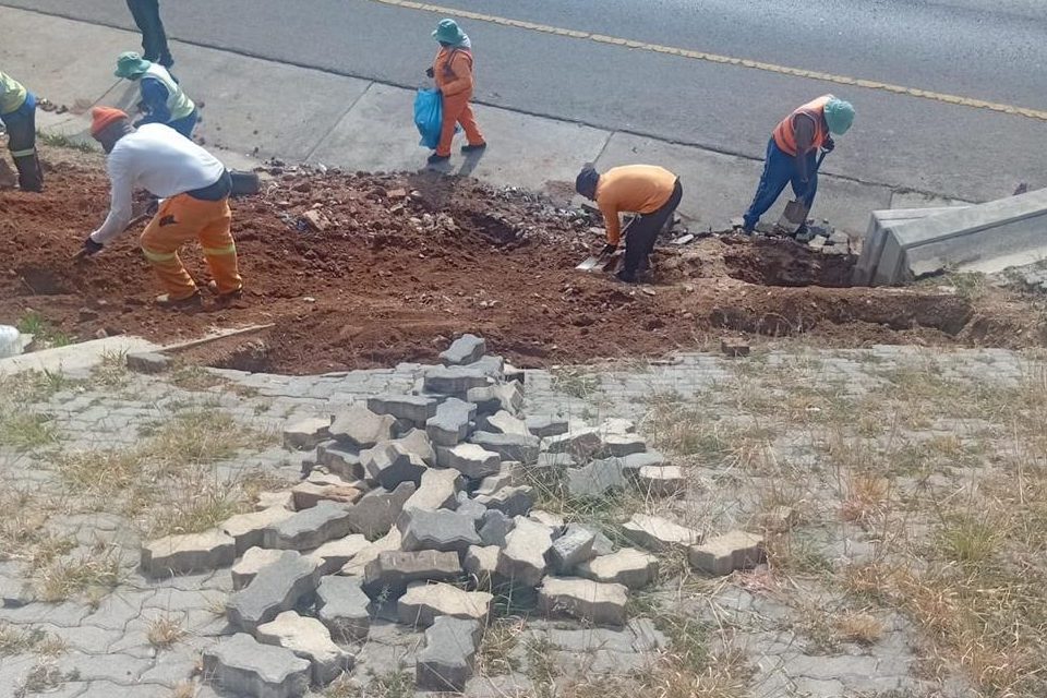 Block paving lifted and stacked while the ground beneath is excavated
