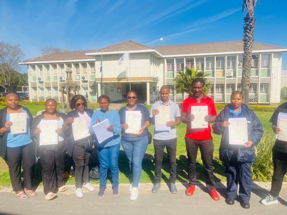 Group of learners with their certificates of competence after a completed programme
